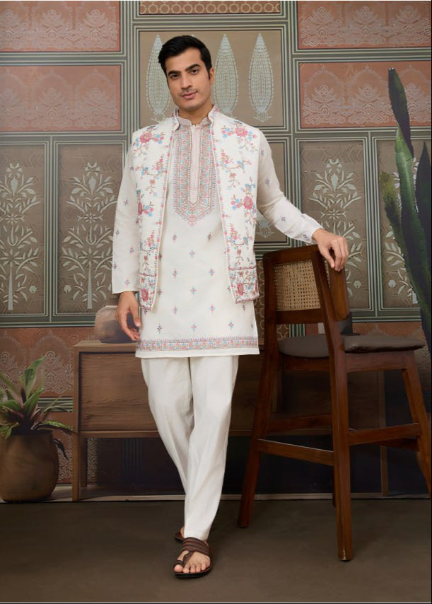 Man wearing a traditional embroidered outfit in a decorated room