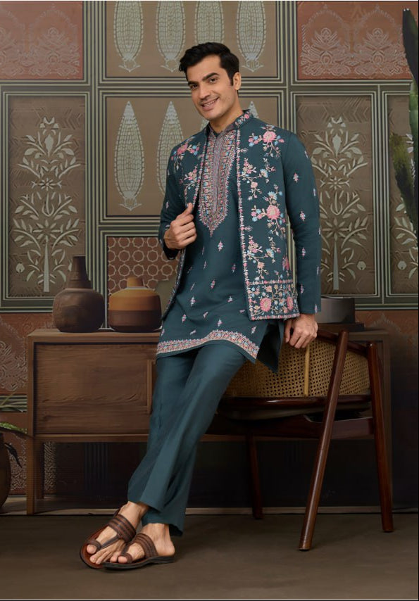Man wearing a traditional outfit in a decorative room with patterned walls.