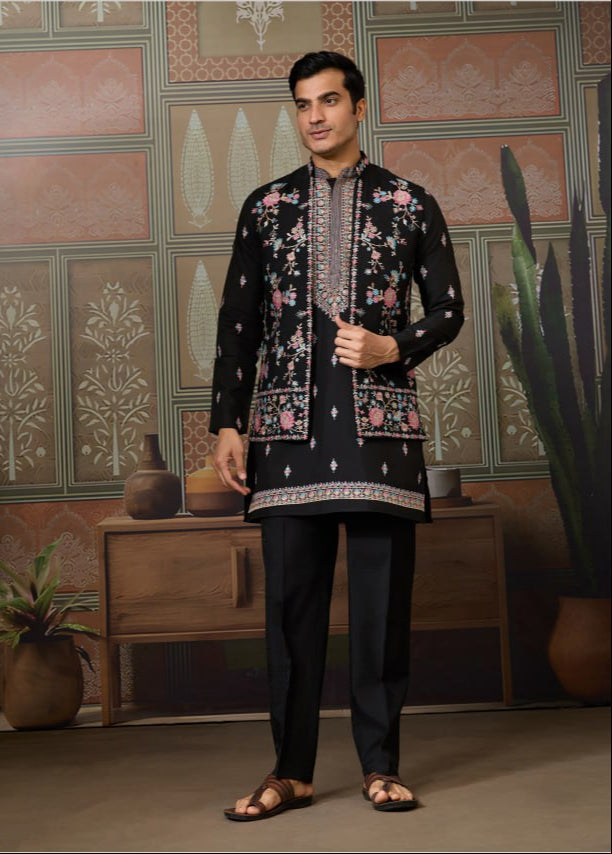 Man wearing a traditional embroidered outfit in a decorated room