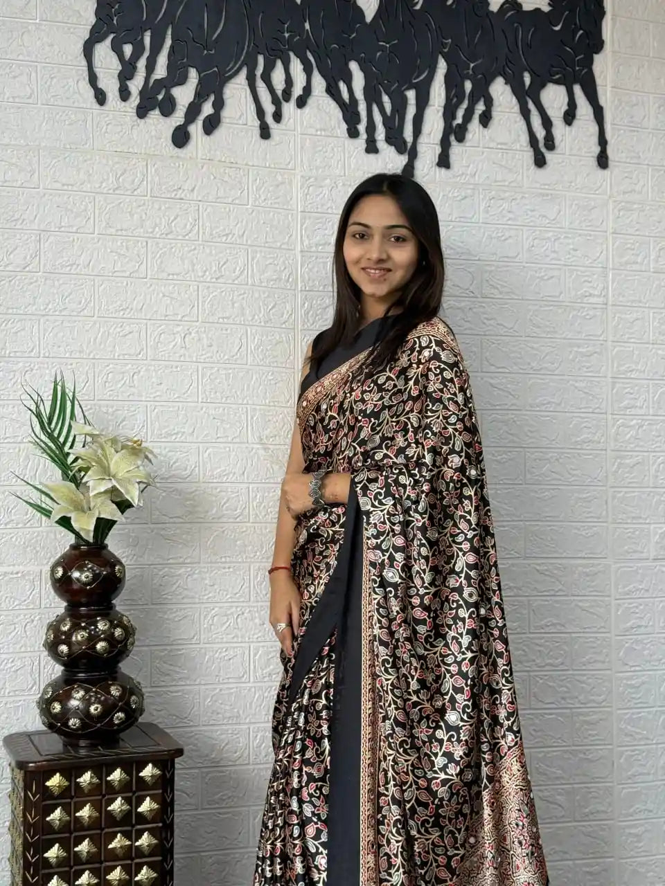 Close-up of real mirror work on black mal cotton saree