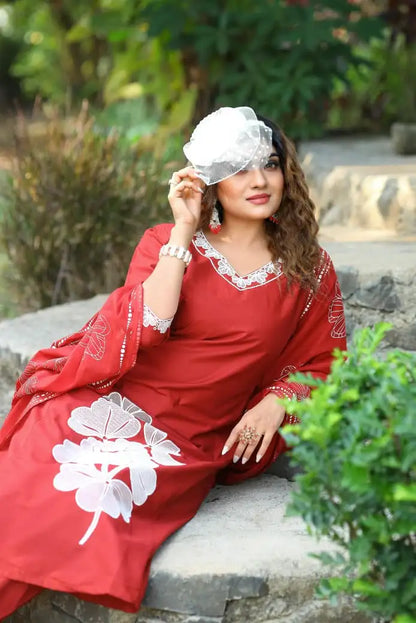 Close-up of embroidery work on maroon pure cotton A-line kurti
