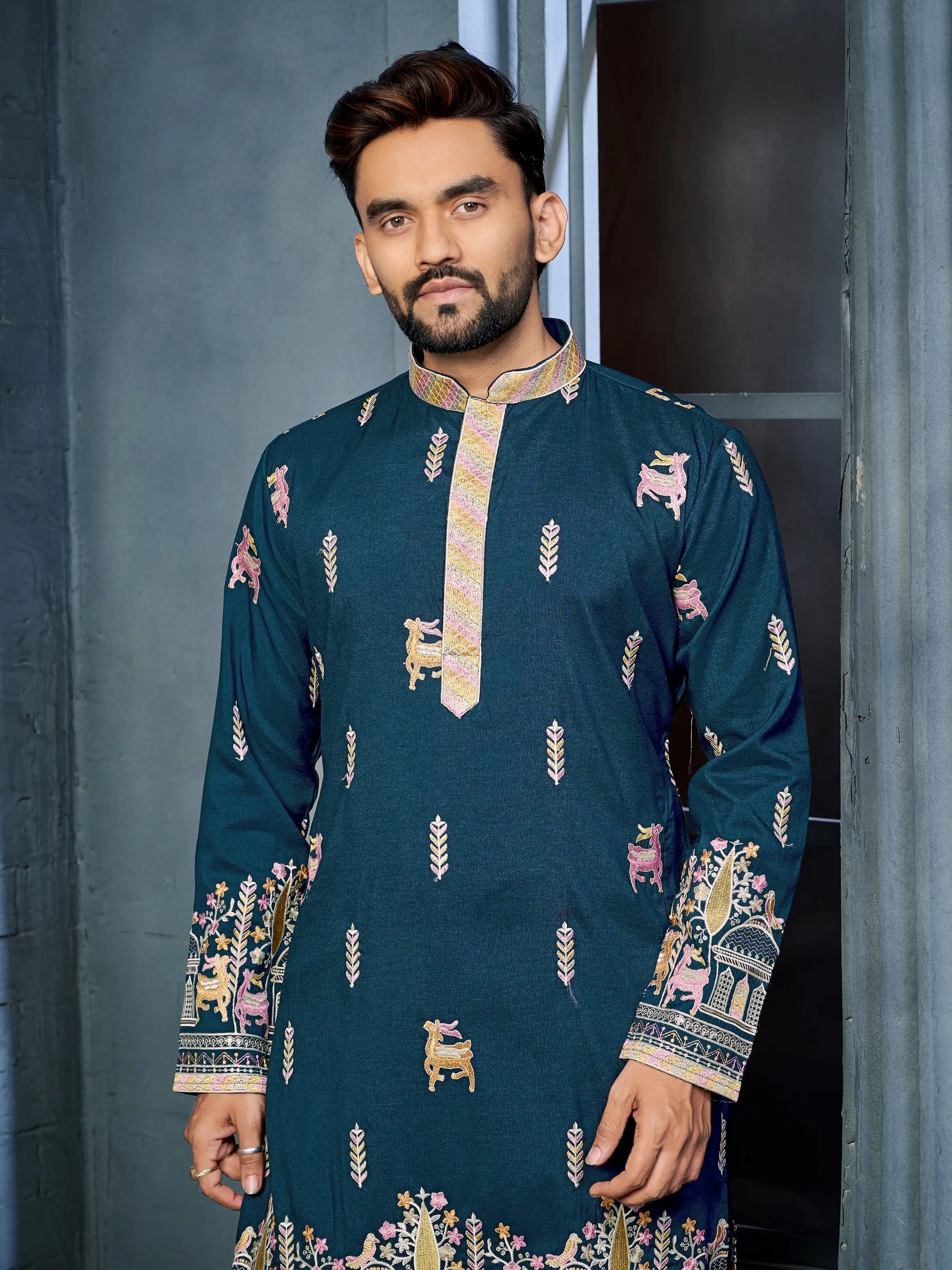 Close-up of deer pattern embroidery on teal blue daaman concept kurta
