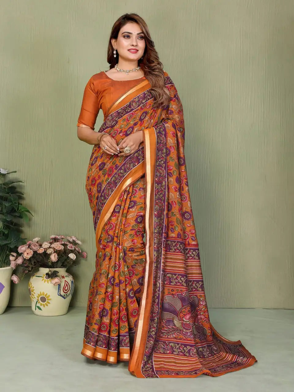 Mul cotton saree with traditional Kalamkari print featuring floral and mythological motifs in earthy tones