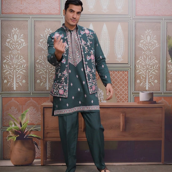 Man wearing a yellow embroidered sherwani in a decorated room.
